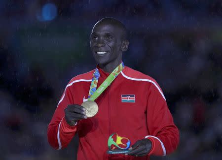 2016 Rio Olympics - Athletics - Victory Ceremony - Men's Marathon Victory Ceremony - Maracana Stadium - Rio de Janeiro, Brazil - 21/08/2016. Eliud Kipchoge (KEN) of Kenya poses with his gold medal. REUTERS/Stoyan Nenov