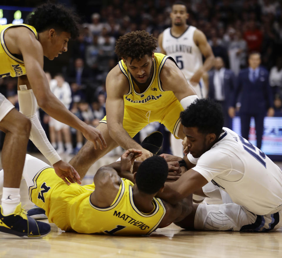 Villanova's Saddiq Bey, from right, and Michigan's Isaiah Livers, Charles Matthews and Eli Brooks struggle for a loose ball during the first half of an NCAA college basketball game, Wednesday, Nov. 14, 2018, in Villanova. (AP Photo/Matt Slocum)