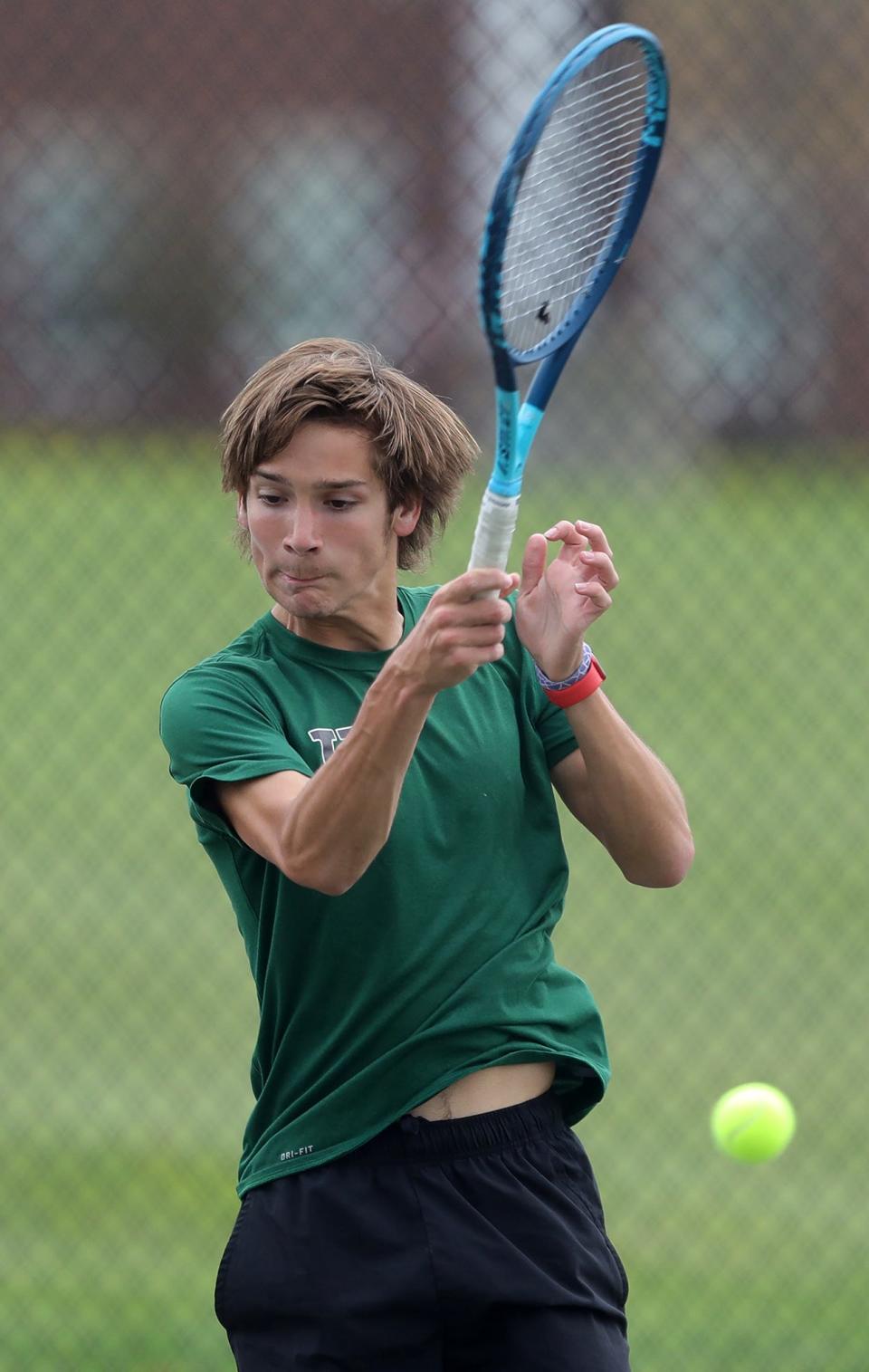 Elijah Hadler of Highland sends a ball back over the net during a tennis match against Tallmadge on Monday that was postponed to Thursday because of rain.