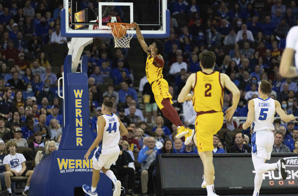 Iowa State's Tyrese Hunter (11), second left, dunks over Creighton's Ryan Hawkins (44) and Alex O'Connell (5) during the first half of an NCAA college basketball game Saturday, Dec. 4, 2021, at CHI Health Center in Omaha, Neb. (AP Photo/Rebecca S. Gratz)