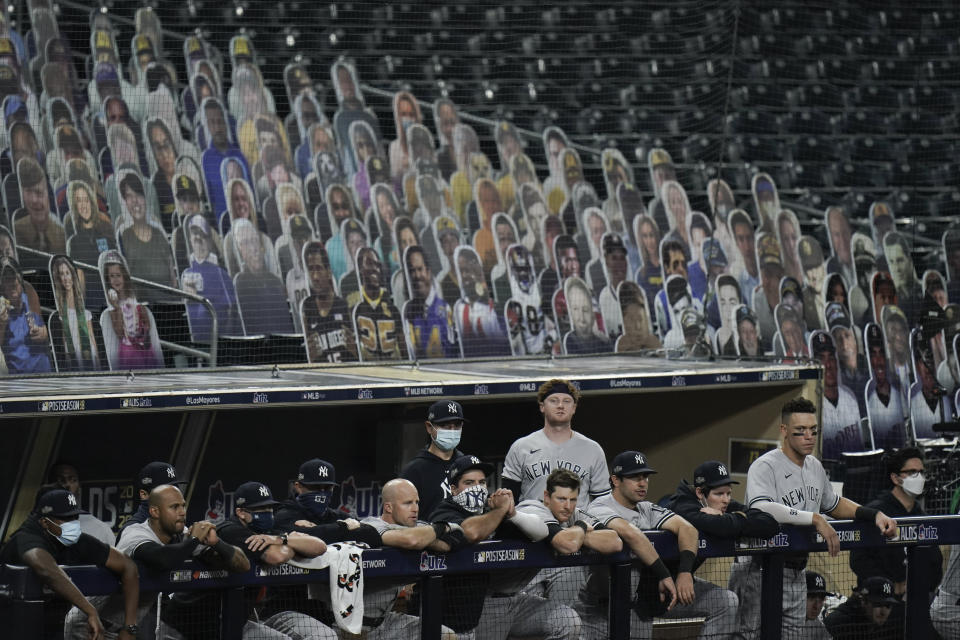 New York Yankees players watch from the dugout during the ninth inning in Game 5 of a baseball American League Division Series against the Tampa Bay Rays, Friday, Oct. 9, 2020, in San Diego. (AP Photo/Jae C. Hong)