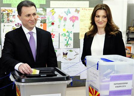 Macedonian Prime Minister Nikola Gruevski casts his ballots next to his wife Borkica at a polling station in Skopje April 27, 2014. REUTERS/Ognen Teofilovski