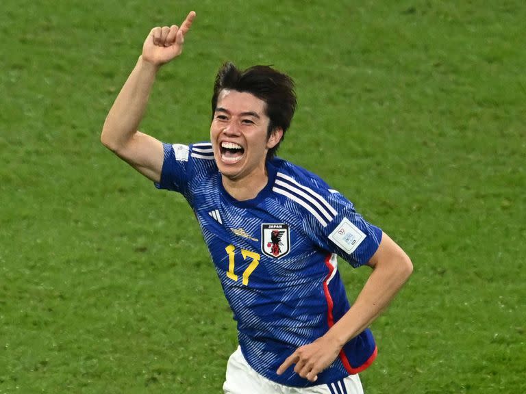 Japan's midfielder #17 Ao Tanaka celebrates scoring his team's second goal with his teammates during the Qatar 2022 World Cup Group E football match between Japan and Spain at the Khalifa International Stadium in Doha on December 1, 2022. (Photo by Jewel SAMAD / AFP)
