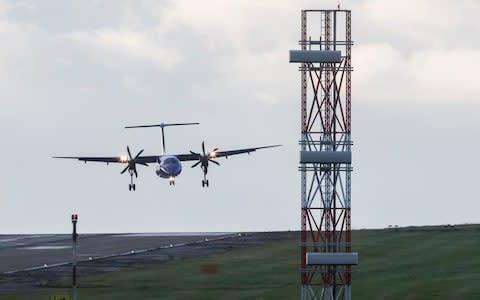A plane lands at Leeds Bradford Airport as Storm Aileen brings howling gusts and heavy showers to parts of the UK - Credit: Danny Lawson/PA