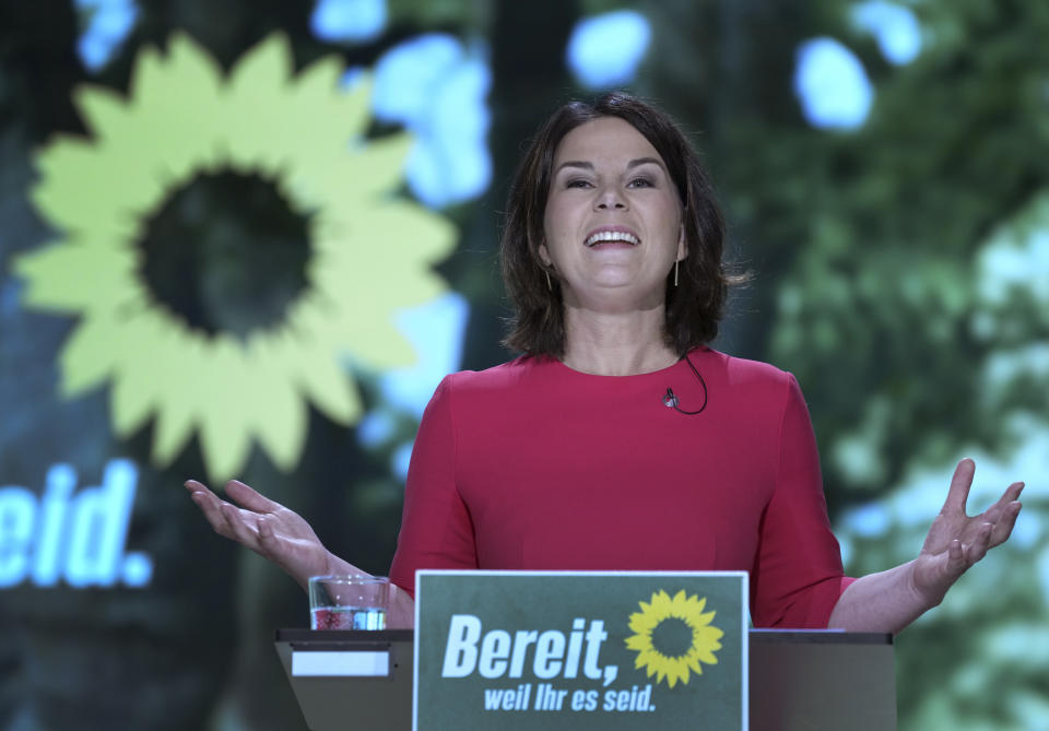 Germany's Green Party co-chairwoman Annalena Baerbock delivers a speech after beeing nominated as the party's chancellor candidate during a party convention of the Green Party in Berlin, Germany, Saturday, June 12, 2021. Slogan reads 'ready, because you are'. (AP Photo/Michael Sohn, pool)