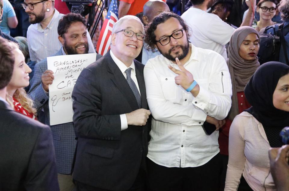 New York City Comptroller Scott Stringer watches poll results as a supporter poses for photographs at the campaign headquarters of Queens district attorney candidate Tiffany Caban Tuesday, June 25, 2019, in the Queens borough of New York. (AP Photo/Frank Franklin II)