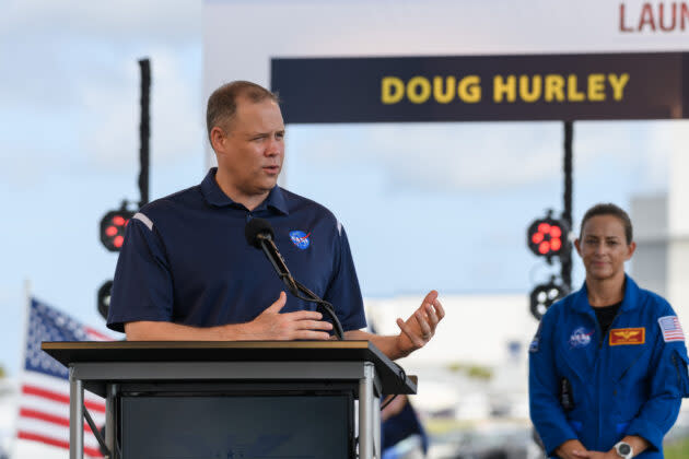 NASA Administrator Jim Bridenstine takes a question during a briefing at Kennedy Space Center’s countdown clock with NASA astronaut Nicole Mann standing behind him. (GeekWire Photo / Kevin Lisota)