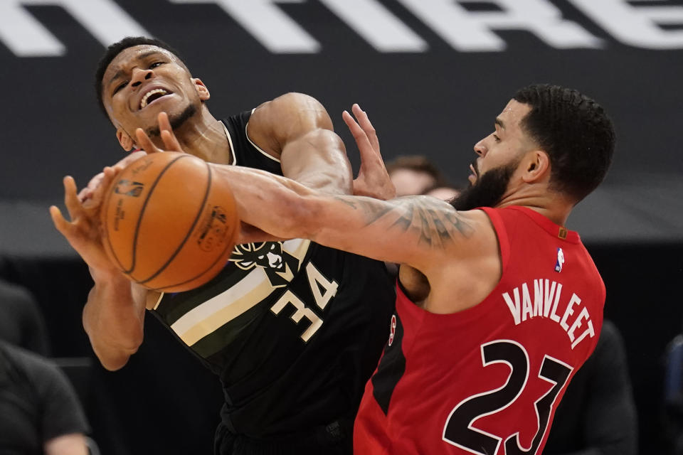 Toronto Raptors guard Fred VanVleet (23) fouls Milwaukee Bucks forward Giannis Antetokounmpo (34) during the second half of an NBA basketball game Wednesday, Jan. 27, 2021, in Tampa, Fla. (AP Photo/Chris O'Meara)