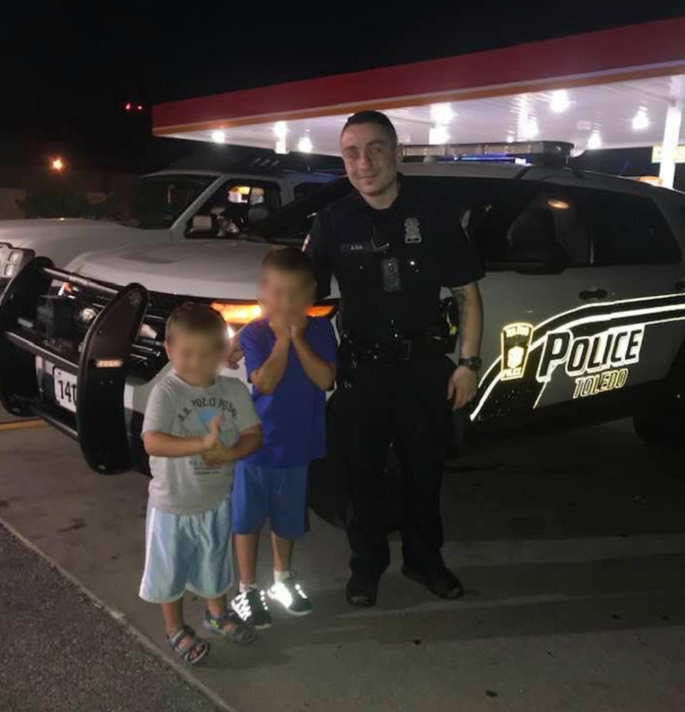 Officer Anthony Dia poses with two children hours before being killed. Source: Facebook