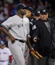 Home plate umpire Gerry Davis ejects New York Yankees starting pitcher Michael Pineda after a foreign substance was discovered on his neck in the second inning of the Yankees' baseball game against the Boston Red Sox at Fenway Park in Boston, Wednesday, April 23, 2014. (AP Photo/Elise Amendola)