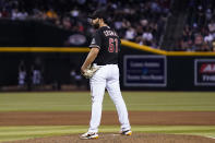 Arizona Diamondbacks relief pitcher Nabil Crismatt pauses on the mound after giving up a run to the Cincinnati Reds on a balk during the 11th inning of a baseball game Saturday, Aug. 26, 2023, in Phoenix. The Reds won 8-7. (AP Photo/Ross D. Franklin)