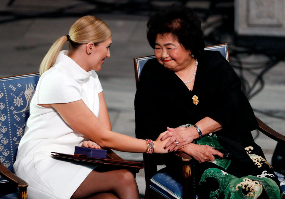 Hiroshima nuclear bombing survivor Setsuko Thurlow touches the hand of Beatrice Fihn, left, during the award ceremony of the 2017 Nobel Peace Prize at the city hall in Oslo, Norway, on Dec. 10, 2017.<span class="copyright">Odd Andersen—AFP/Getty Images</span>