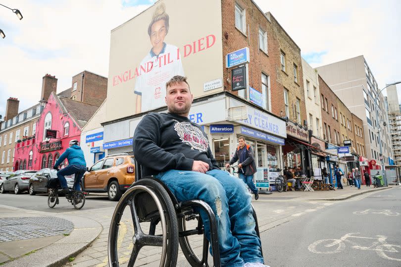 Charlie Peverall at the mural of his sister Libbey Peverall who tragically died at age 20 from a cardiac arrest