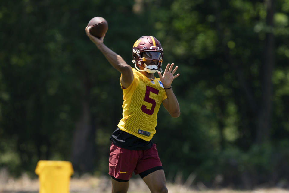 Washington Commanders quarterback Javden Daniels (5) throws a pass during NFL football practice in Ashburn, Va., Wednesday, May 22, 2024. (AP Photo/Jose Luis Magana)