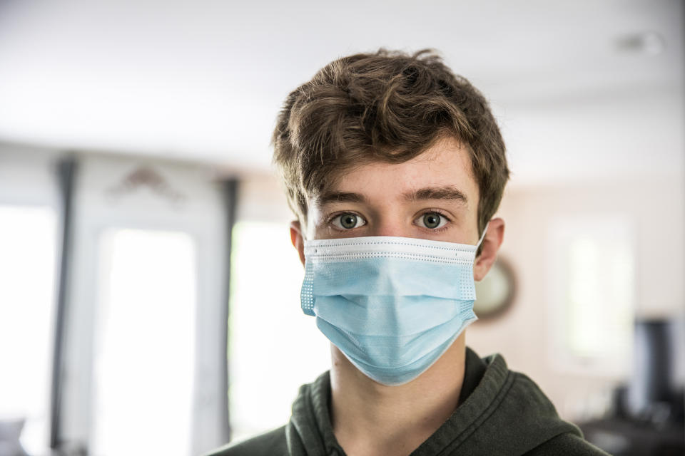 Teenage boy wearing surgical mask