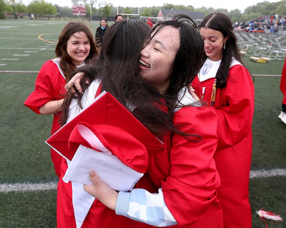 Hingham High graduate Sherry Sze hugs Grace Desai after their graduation ceremony for the Class of 2023 on Saturday, June 3, 2023. Hingham High graduated 318 seniors. 