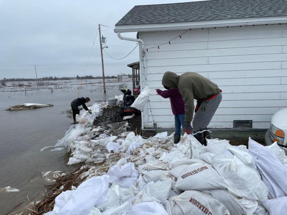Crews were busy sandbagging in Peguis First Nation to help keep homes protected as more rain is expected in the coming days.  (Jaison Empson/CBC - image credit)