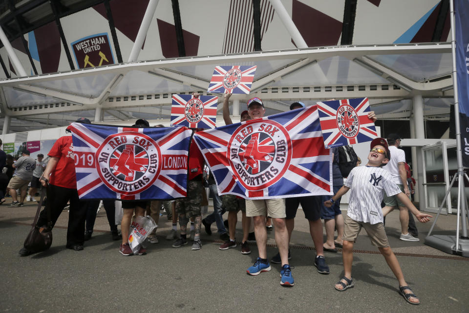 Fans pose for a picture outside London Stadium before a baseball game between the New York Yankees and the Boston Red Sox in London, Sunday, June 30, 2019. (AP Photo/Tim Ireland)