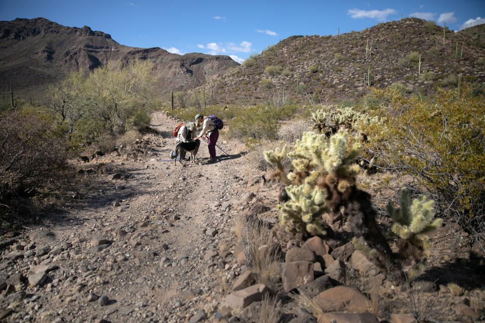 Volunteers for the humanitarian aid group No More Deaths pause while delivering water along remote trails on May 11, 2019 near Ajo, Arizona. (Photo: John Moore via Getty Images)