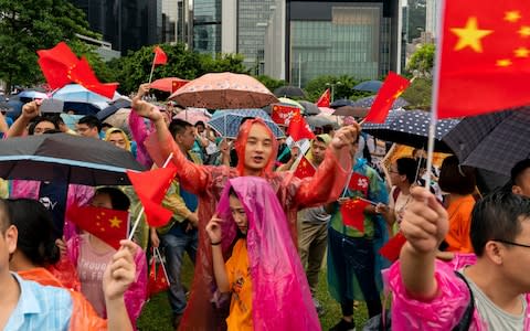 Pro-Beijing supporters hold national flag during a pro-government rally at Tamar Park on Saturday - Credit: Billy H.C. Kwok/Getty Images AsiaPac