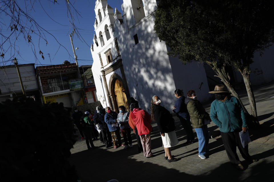 People over age 60 wait to receive the AstraZeneca vaccine for COVID-19 as Mexico begins vaccinating its elderly population for the new coronavirus in the outlying Milpa Alta borough of Mexico City, Monday, Feb. 15, 2021. (AP Photo/Rebecca Blackwell)