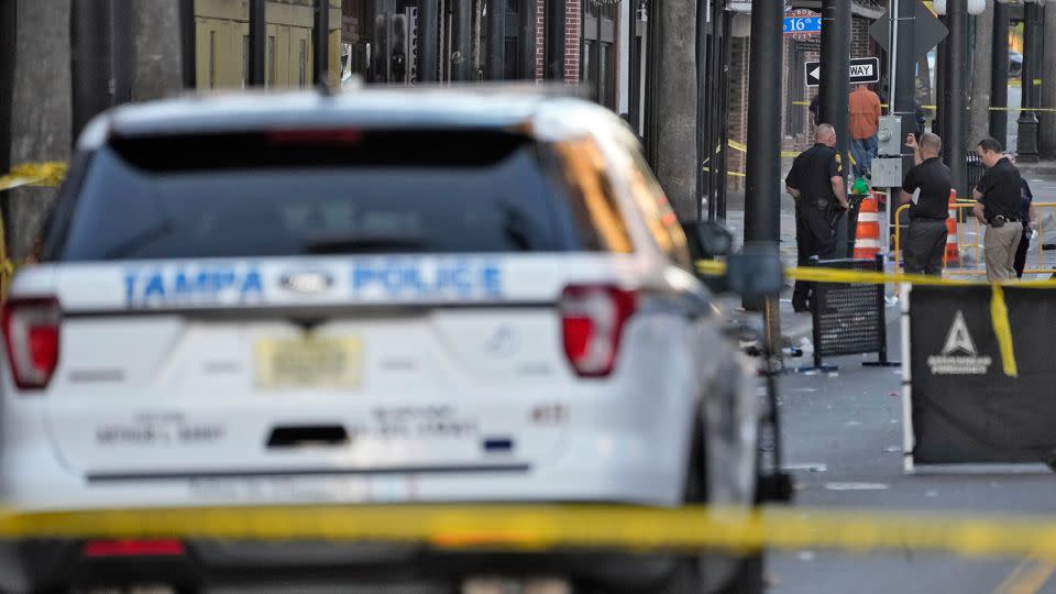 Tampa police officers stand in the street in the Ybor City of Tampa after a shooting Sunday. - Chris O'Meara/AP