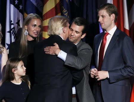 U.S. President-elect Donald Trump embraces his son Donald Trump Jr. during his election night rally in Manhattan, New York, U.S., November 9, 2016. REUTERS/Mike Segar
