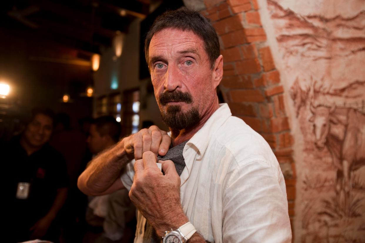 Software company founder John McAfee adjusts a microphone in preparation for an interview in Guatemala City on Dec. 4, 2012.