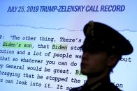 FILE PHOTO: A Capitol Hill Police officer is silhouetted before a Trump-Zelensky call record at the House Intelligence Committee hearing as part of Trump impeachment inquiry on Capitol Hill in Washington