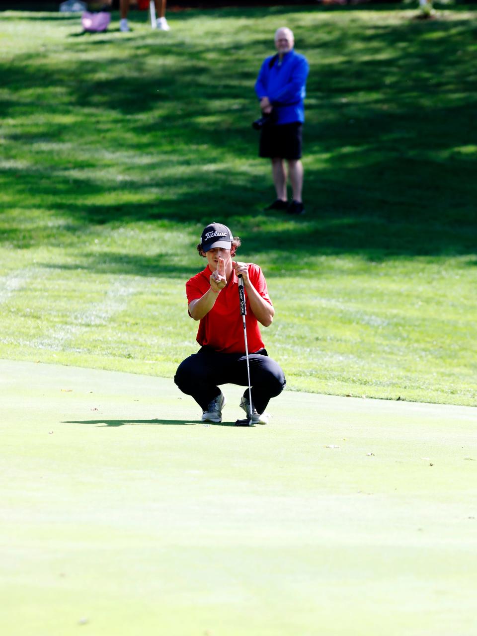 Hiland's Camden Bille lines up a putt on the 27th hole during a Division III district golf tournament on Wednesday, Oct. 2, 2024, at River Greens in West Lafayette. Bille shot 75 to earn the lone indivdual qualifying spot at next week's state tournament at North Star Golf Club in Sunbury.