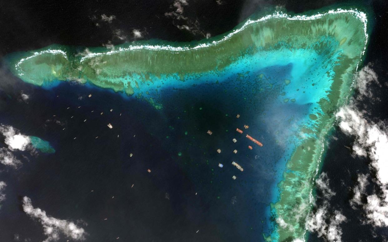 Chinese vessels anchored at the Whitsun Reef, around 175 nautical miles west of Bataraza in Palawan in the South China Sea. The boats gathered near a disputed reef in the South China Sea are ‘fishing boats’ sheltering from poor weather, the China foreign ministry said March 22, a day after the Philippines described their presence as an incursion -  AFP