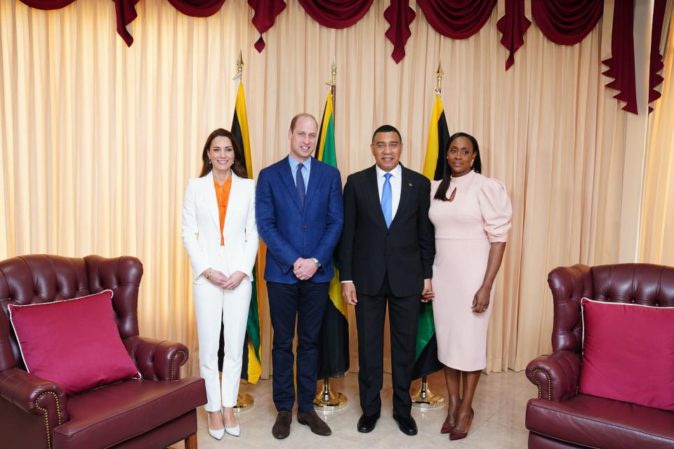 KINGSTON, JAMAICA - MARCH 23: Prince William, Duke of Cambridge (2nd L) and Catherine, Duchess of Cambridge (L) pose for a photograph with the Prime Minister of Jamaica, Andrew Holness (2nd R) and his wife Juliet (R) during a meeting at his office on March 23, 2022 in Kingston, Jamaica. The Duke and Duchess of Cambridge are visiting Belize, Jamaica and The Bahamas on behalf of Her Majesty The Queen on the occasion of the Platinum Jubilee. The 8 day tour takes place between Saturday 19th March and Saturday 26th March and is their first joint official overseas tour since the onset of COVID-19 in 2020. (Photo by Jane Barlow - Pool/Getty Images)