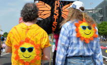 Men with cartoon suns wearing sunglasses on their backs stand with a "RESIST" sign as they await the start of a march by demonstrators down Pennsylvania Avenue during a People's Climate March, to protest U.S. President Donald Trump's stance on the environment, in Washington, U.S., April 29, 2017. REUTERS/Mike Theiler