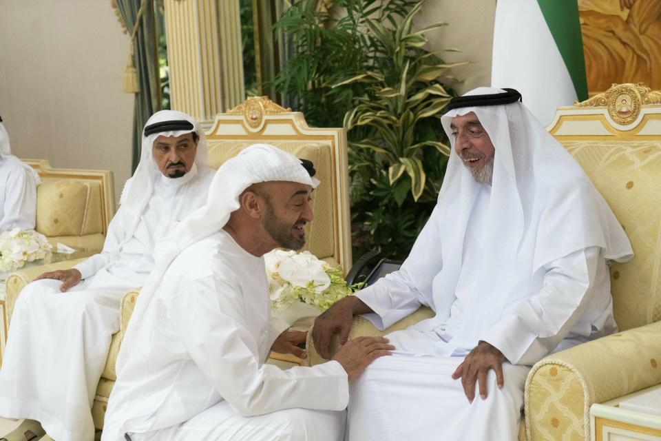 FILE - This photo by Emirates News Agency, WAM, Sheikh Khalifa bin Zayed Al Nahyan, the president of the United Arab Emirates and ruler of Abu Dhabi, right, is greeted by Sheikh Mohammed bin Zayed Al Nahyan, the crown prince of Abu Dhabi, center, as Sheikh Humaid bin Rashid Al Nuaimi, the ruler of Ajman, left, looks on at Al Bateen Palace in Abu Dhabi, United Arab Emirates, In this Wednesday, May 8, 2019. Sheikh Khalifa died Friday, May 13, 2022, the government's state-run news agency announced in a brief statement. He was 73. (Rashed al-Mansoori/Ministry of Presidential Affairs via AP, File)