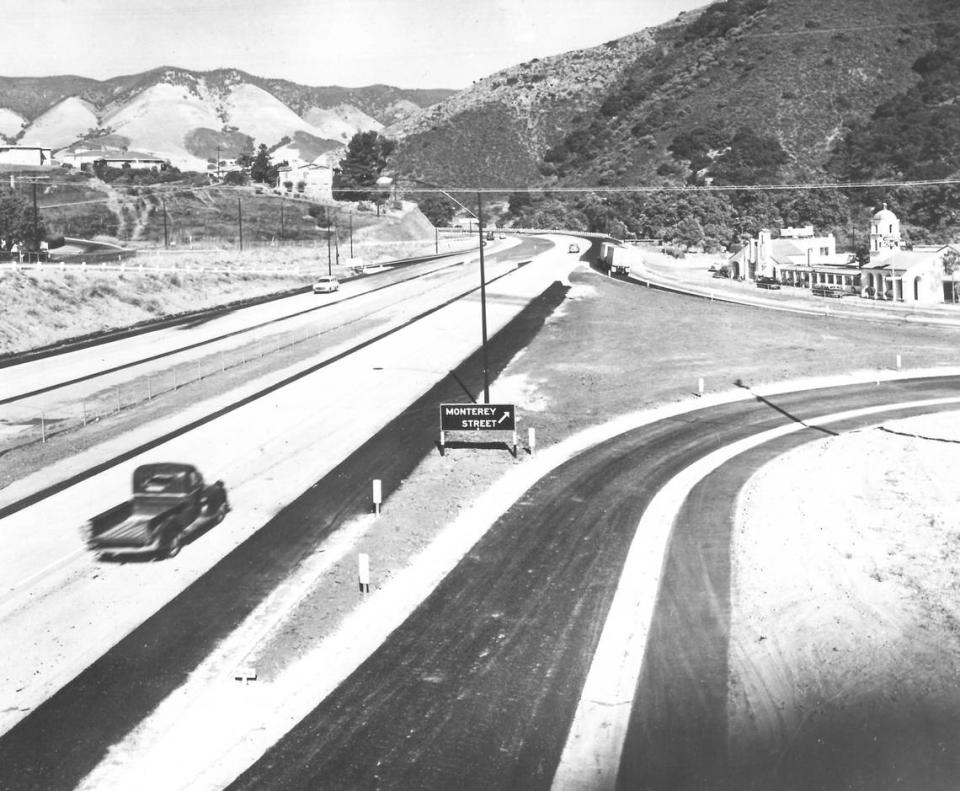 A photo shows northbound Highway 101 in San Luis Obispo, with the Monterey Street exit, Motel Inn and Cuesta Grade in the background, circa 1960.