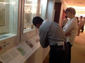 Visitors to the exhibition reading some of the handwritten letters on display. (Yahoo! photo)