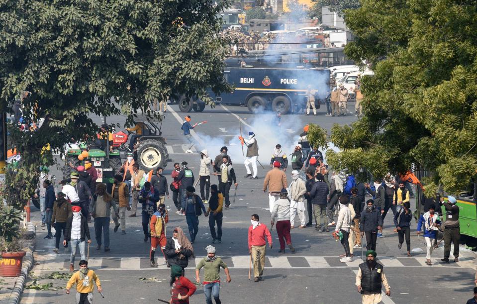 NEW DELHI, INDIA - JANUARY 26: Tear gas fired by police to stop protesting farmers on tractors after they entered the city on Republic Day at ITO on January 26, 2021 in New Delhi, India. Major scenes of chaos and mayhem at Delhi borders as groups of farmers allegedly broke barricades and police check posts and entered the national capital before permitted timings. Police used tear gas at Delhi's Mukarba Chowk to bring the groups under control. Clashes were also reported at ITO, Akshardham. Several rounds of talks between the government and protesting farmers have failed to resolve the impasse over the three farm laws. The kisan bodies, which have been protesting in the national capital for almost two months, demanding the repeal of three contentious farm laws have remained firm on their decision to hold a tractor rally on the occasion of Republic Day.(Photo by Arvind Yadav/Hindustan Times via Getty Images)