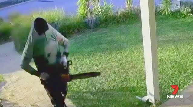 A man was captured on security camera hacking at a woman's house with a chainsaw. Photo: 7 News