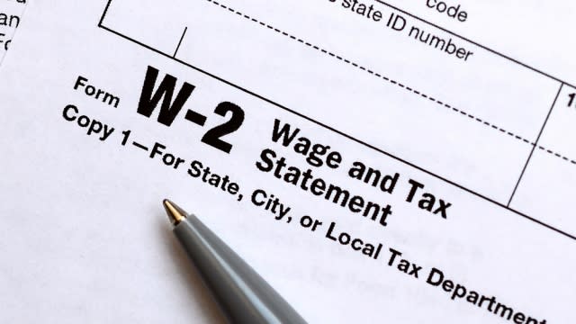 Pen lies on the tax form W-2 Wage and Tax Statement.