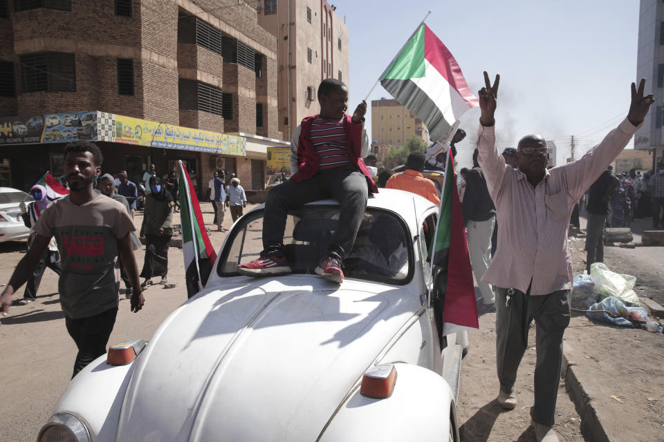 People chant slogans during a protest to denounce the October military coup, in Khartoum, Sudan, Thursday, Dec. 30, 2021. The October military takeover upended a fragile planned transition to democratic rule and led to relentless street demonstrations across Sudan. (AP Photo/Marwan Ali)