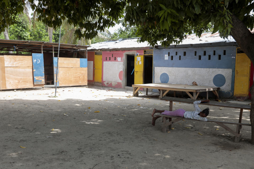 A girl rests in the courtyard of the school funded by El Roi Haiti in the Cite Soleil neighborhood of Port-au-Prince, Haiti, Monday, July 31, 2023. The non profit organization said in a statement that Alix Dorsainvil, a nurse who works for El Ron Haiti, and her daughter were kidnapped July 27. (AP Photo/Odelyn Joseph)