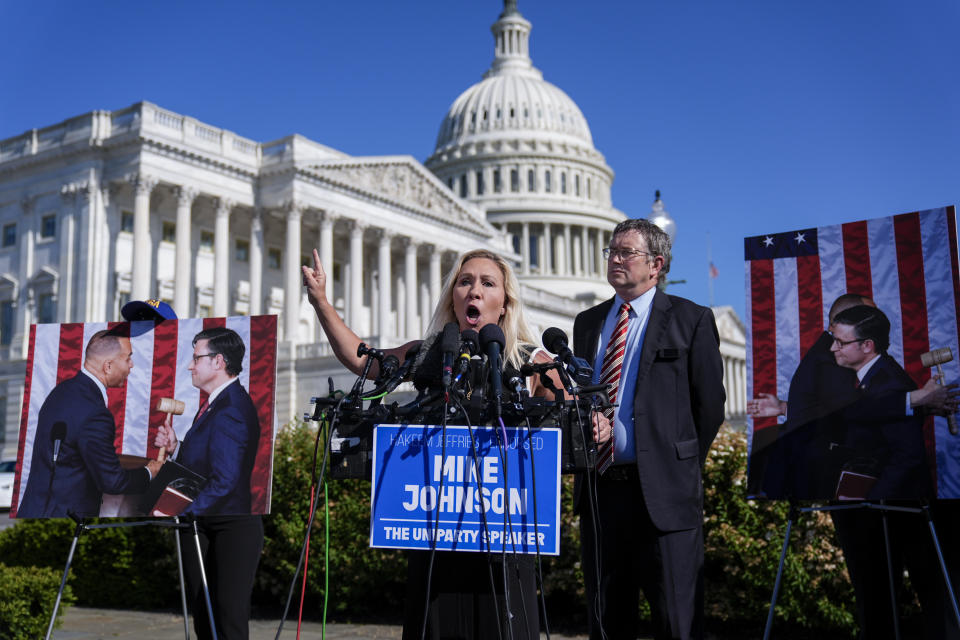 Rep. Marjorie Taylor Greene, R-Ga., joined by Rep. Thomas Massie, R-Ky., says she'll call a vote next week on ousting House Speaker Mike Johnson, R-La., during a news conference at the Capitol in Washington, Wednesday, May 1, 2024. Rep. Greene, a staunch ally of former President Donald Trump, is forcing her colleagues to choose sides after Democratic leaders announced they'd provide the votes to save the Republican speaker's job. (AP Photo/J. Scott Applewhite)