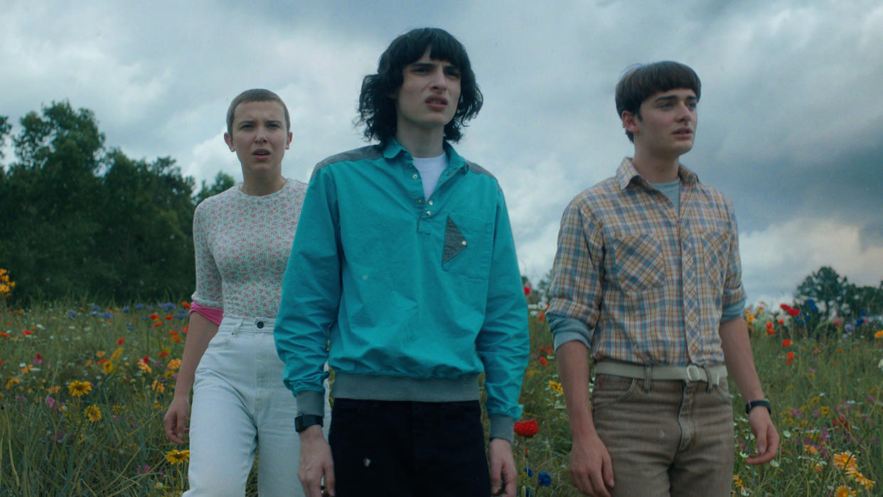  Eleven, Mike, and Will stare into the distance from a hill in Stranger Things season 4 