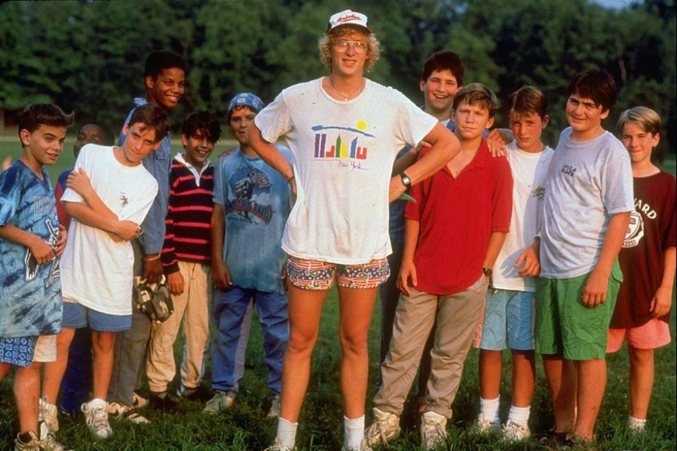 Camp director standing in front of kids and campers in the background