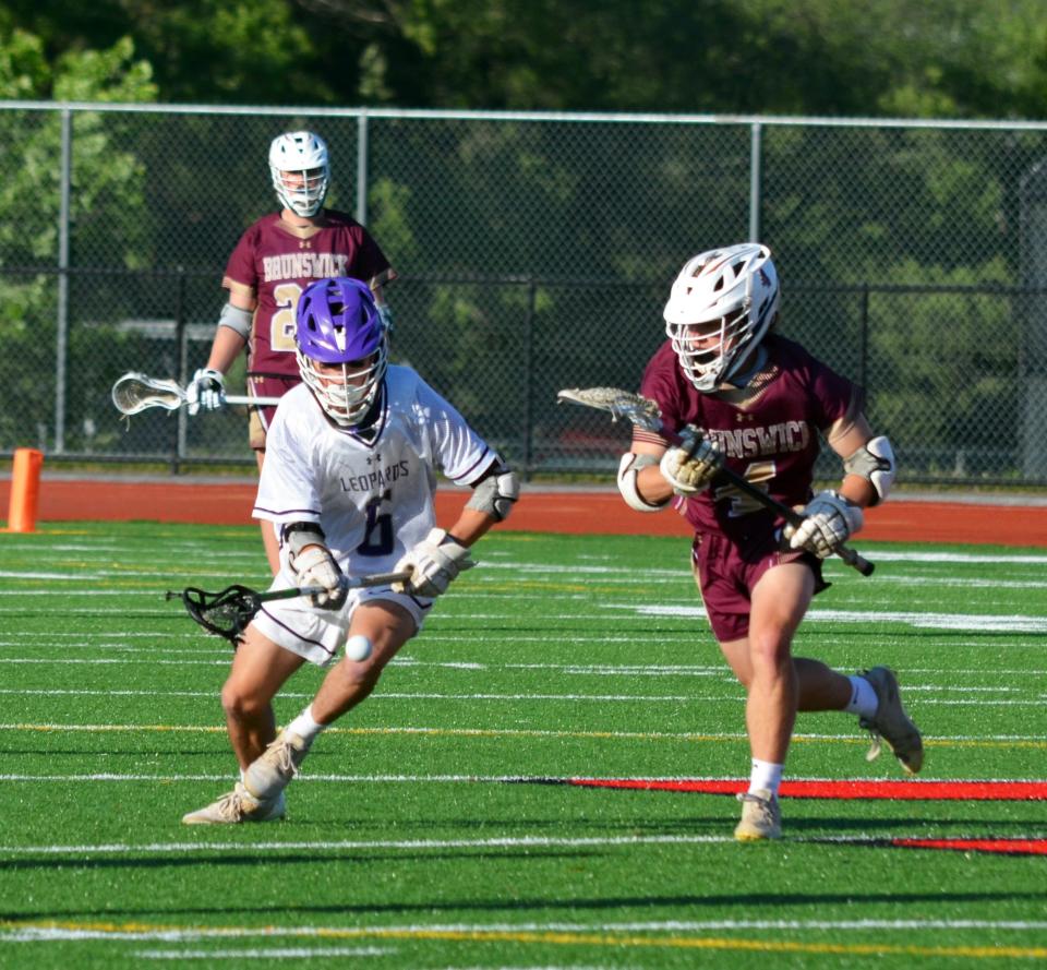 Smithsburg's Clark Smith, left, wins a faceoff against Brunswick's Isaac Herbert during the Leopards' 11-4 victory in the 1A West Region II final.