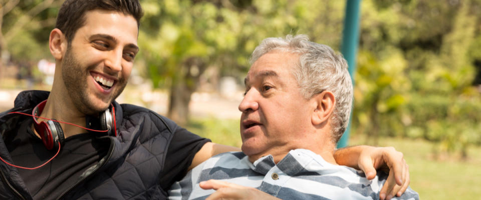 Dad and son talking in the park