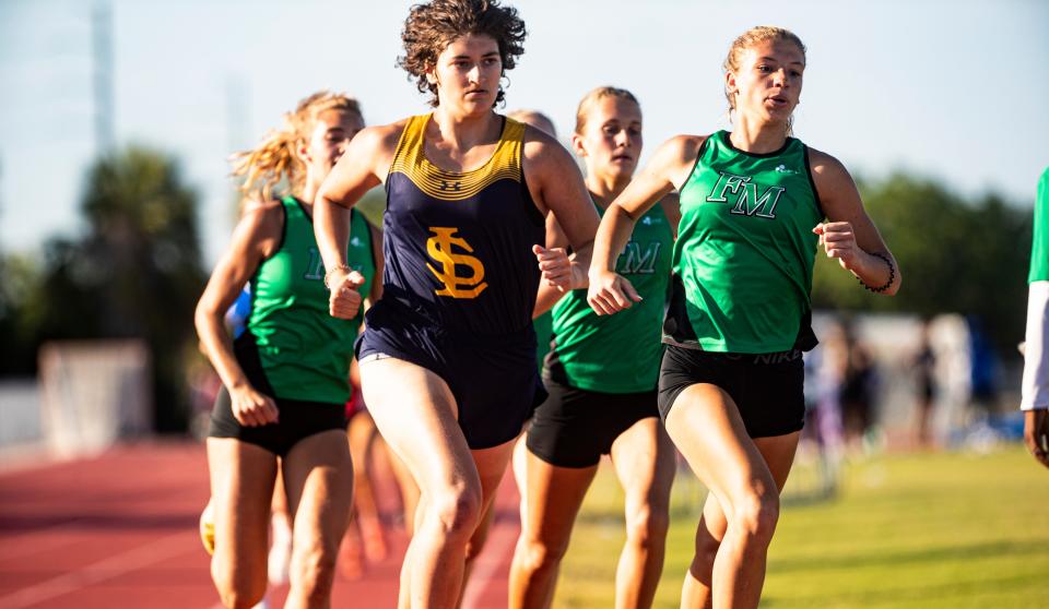 Gianna Del Pizzo, left, of Lehigh Senior High School leads the girls 800 during the LCAC Track and Field Championships at Cypress Lake High School on Wednesday, April 17, 2024. She won.