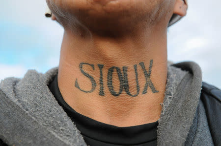 A man from the Lakota Sioux tribe with a Native American tattoo on his neck poses for a photograph during a protest against plans to pass the Dakota Access pipeline near the Standing Rock Indian Reservation, near Cannon Ball, North Dakota, U.S. November 16, 2016. REUTERS/Stephanie Keith