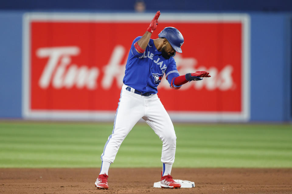 Toronto Blue Jays' Teoscar Hernandez celebrates on second base after hitting a double against the New York Yankees in the fourth inning of baseball game action in Toronto, Monday, Sept. 26, 2022. (Cole Burston/The Canadian Press via AP)