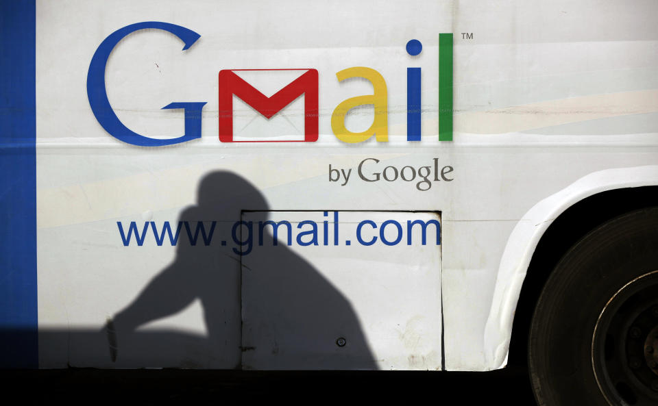 FILE - In this Monday, Sept 17, 2012, file photo an unidentified man's shadow reflects on a commercial bus with an advertisement for Google Mail, in Lagos, Nigeria. Google Inc.'s stock plunged suddenly on Thursday Oct. 18, 2012, after a contractor prematurely released the search company's third-quarter earnings report. (AP Photo/Sunday Alamba)